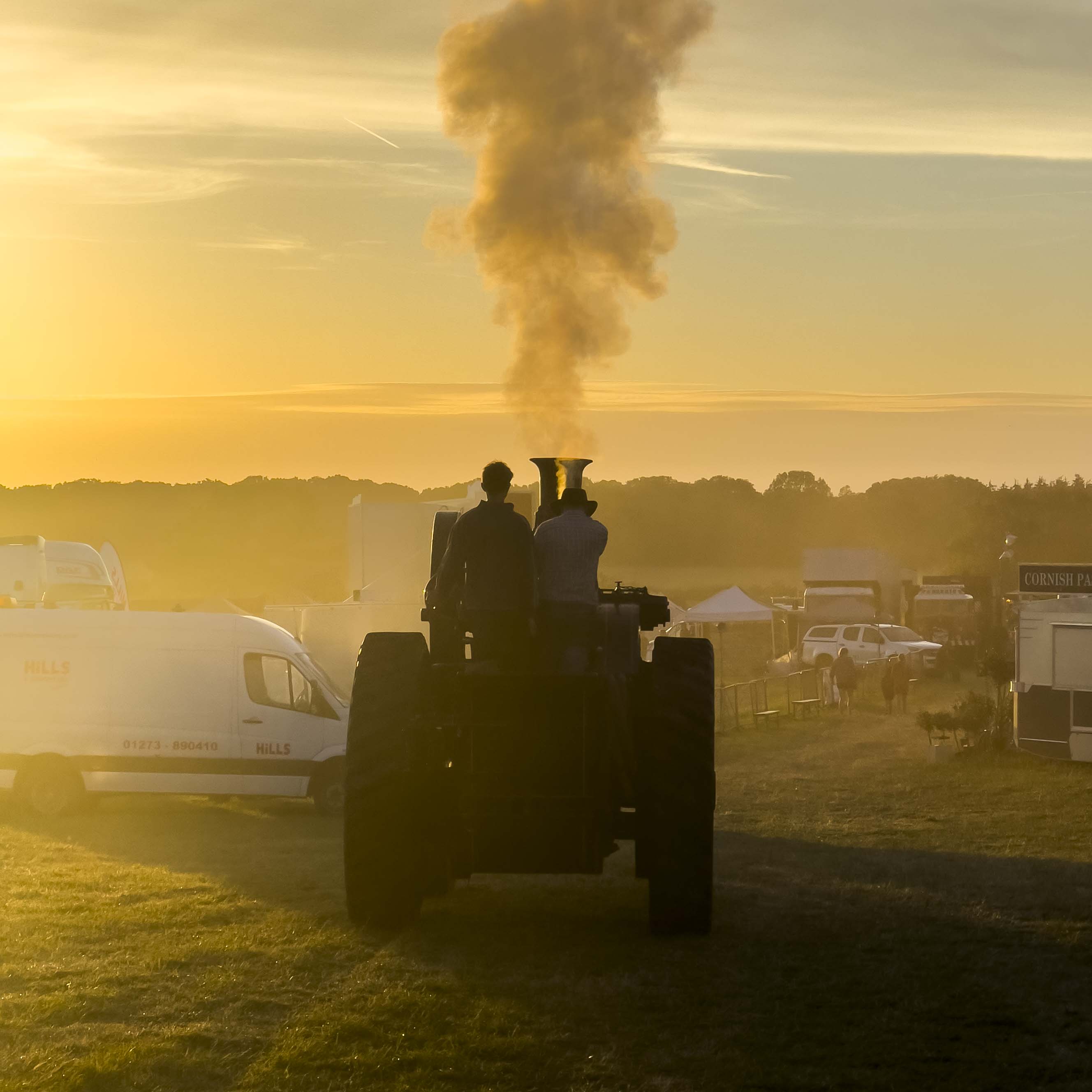 A steam engine with the sunset in the back